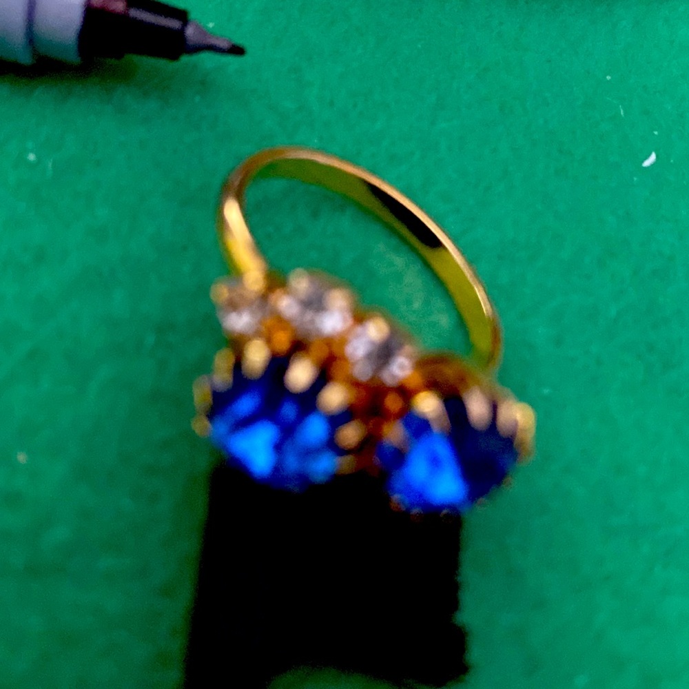 Blue stones and rhine stones in gold setting.  Size adjustable